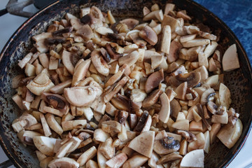 Champignon mushrooms, sacking mat and spices on wooden background