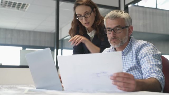 Industrial designers working together on project in office