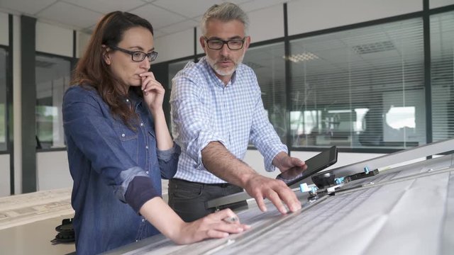 Industrial designers working together on project in office