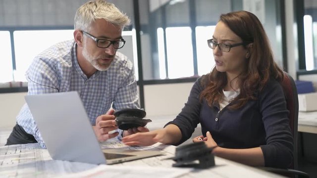 Industrial designers working together on project in office