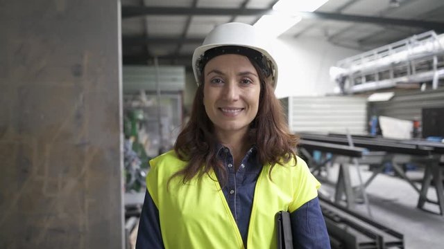 Metal industry engineer in factory talking to camera