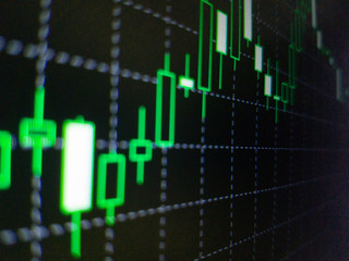 Abstract financial trading graphs on monitor. Background with currency bars and candles