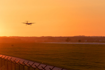 Fototapeta na wymiar Passenger plane approaching at Lech Walesa Airport in Gdansk at sunset time.