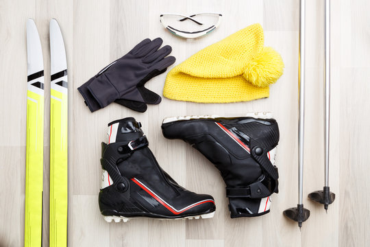 Picture of skier accessories on wooden background.