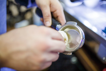 Photo of barista man with mortar for coffee