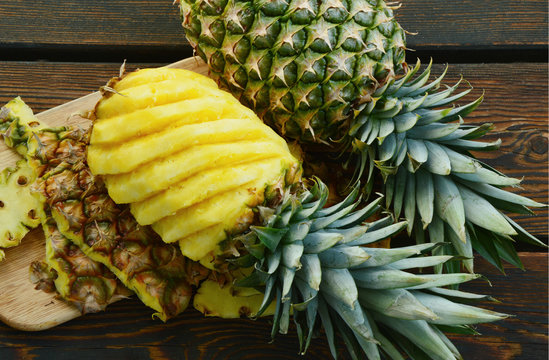 Ananas or Pineapple on wooden background.
way to peel and cut a pineapple. 