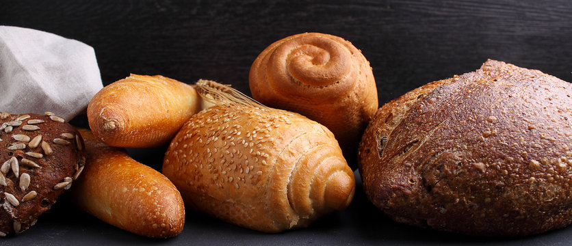 Pile Of Fancy Bread On Black Stone Background