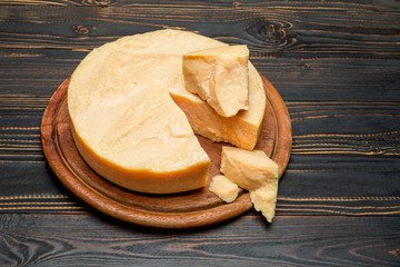 Whole round Head and pieces of parmesan or parmigiano