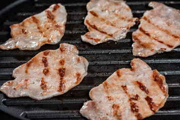 Close up  buffet with  pork cooked on electric barbecue pan.