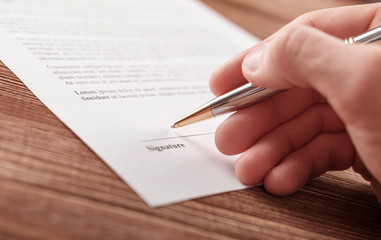 Close up business man signing contract making a deal