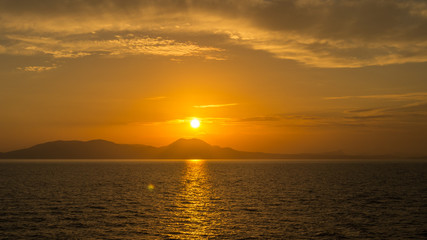 Naklejka na ściany i meble Sunset behind Corfu Island