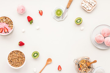 Fototapeta na wymiar Healthy breakfast with yogurt, muesli, fruits, strawberry on grey background, flat lay, top view