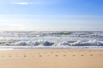 Beautiful ocean waves on the sand beach.