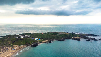 "Aerial view of sandy beach with tourists swimming in beautiful clear sea  water"