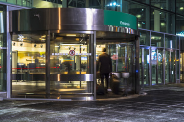 the flow of people through a revolving door at the airport