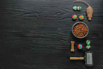 Flat lay composition with cat accessories and food on dark wooden background
