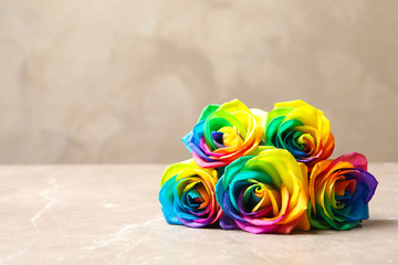 Amazing rainbow rose flowers on table