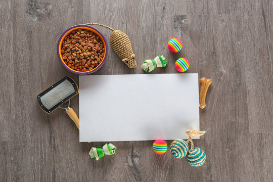Flat lay composition with cat accessories and food on wooden background