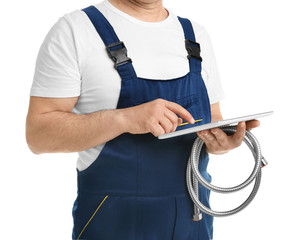 Mature plumber with tablet computer and hose on white background