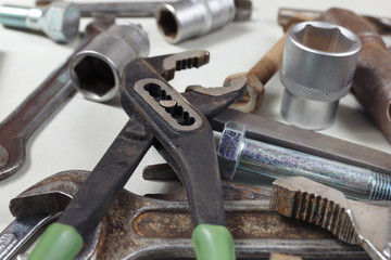 New and rusty wrenches, nuts, bolts and nuts for mechanical work close up