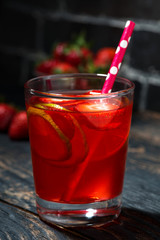strawberry citrus lemonade on a dark background, closeup