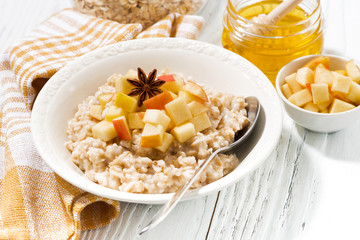 plate of oatmeal with apples and spices