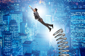 Businessman jumping from spring in promotion concept