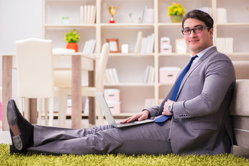 Businessman working on the floor at home