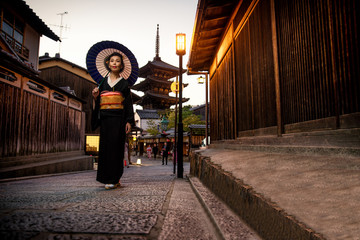 Asian woman with kimono walking at Yasaka Pagoda in Kyoto