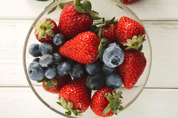 Mixed berries in glass bowls closeup, top view
