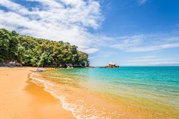Abel Tasman National Park, New Zealand: Magical sandy beach with turquoise blue water on beautiful...