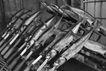 abstract black and white look of atlantic mackerel on grill 