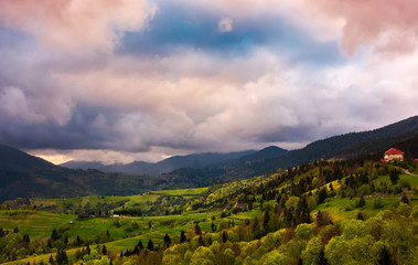 heavy purple clouds over the rural countryside. beautiful landscape of Carpathian mountains in...