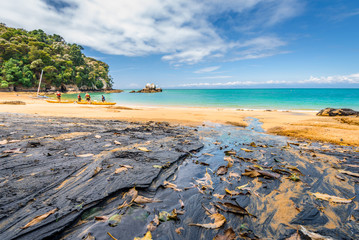 Abel Tasman National Park, New Zealand: Magical sandy beach with turquoise blue water on beautiful...