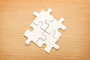 White jigsaw puzzle on wood background