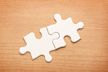 White jigsaw puzzle on wood background