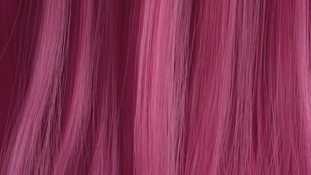 Closeup of pink hair creative colored texture Closeup of combing pink hair