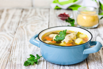 Instant pot turkey meatball soup in a pot on white rustic background. Selective focus, space for text. - obrazy, fototapety, plakaty