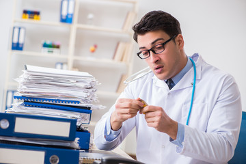 Busy doctor with too much work in hospital