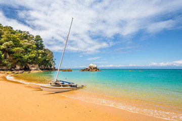 Abel Tasman National Park, New Zealand: Magical sandy beach with turquoise blue water on beautiful...