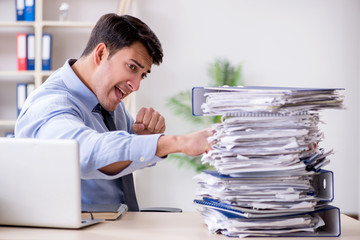 Extremely busy businessman working in office