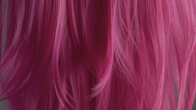 Closeup of pink hair creative colored texture tilt up camera movement