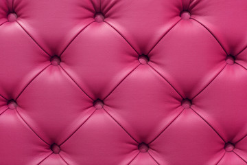 Background of leather pink sofa, stitched buttons.