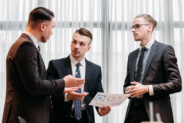 business briefing. leadership. boss talking to his team in office discussing results and giving...