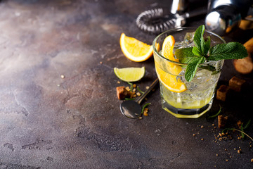 Orange cocktail with ice, leaf of mint and orange slice.