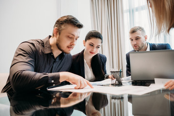 business team communication. ideas brainstorming. men and women discussing documents in office workspace
