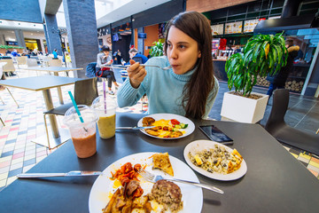 couple sit in mall cafe and having dinner. lifestyle. date in cafe