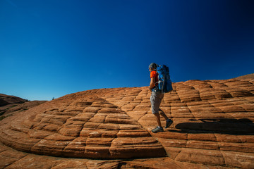 Hiker on a trail in volcanic Snow canyon State Park in Utah, USA © Maygutyak