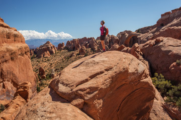 Hiker rests in Arches National park in Utah, USA