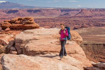 Hiker rests in Canyonlands National park in Utah, USA